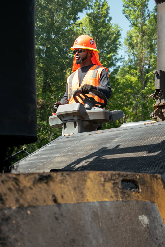 Asphalt paving operation on a two-lane road