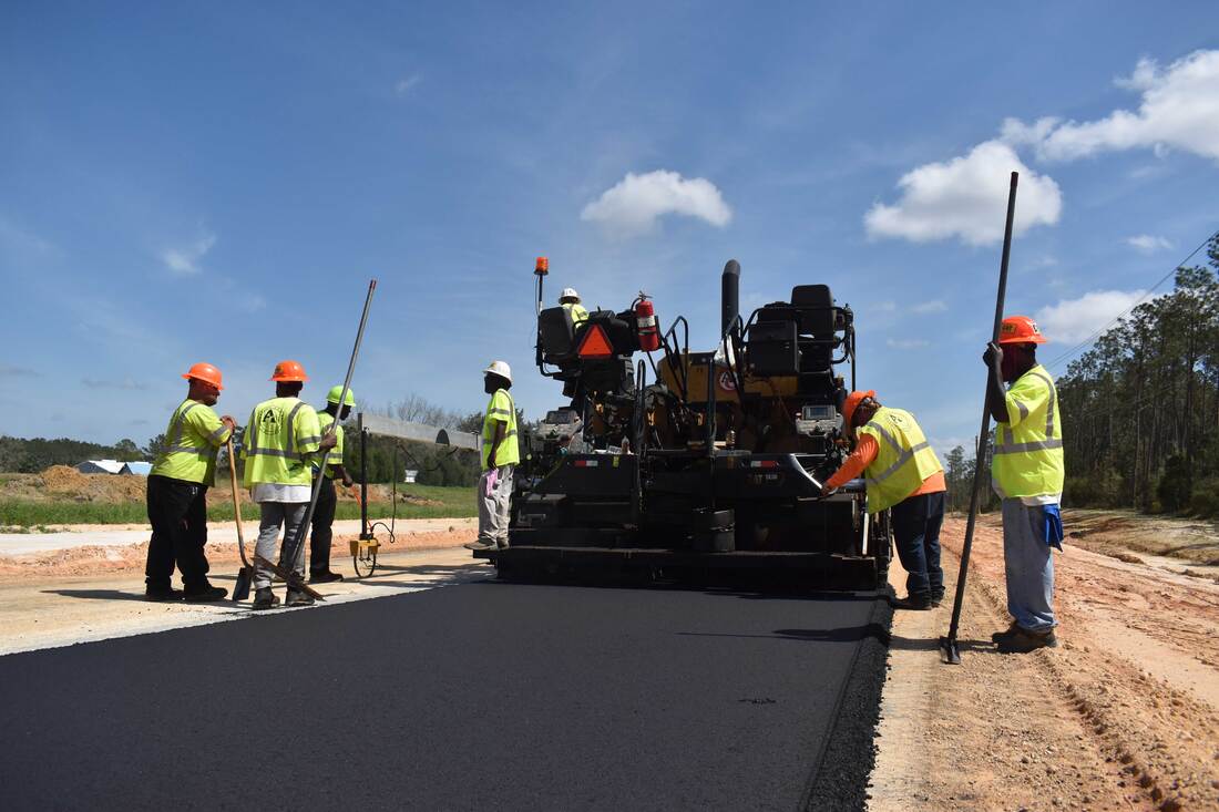 Paving crew constructing a highway roadbed