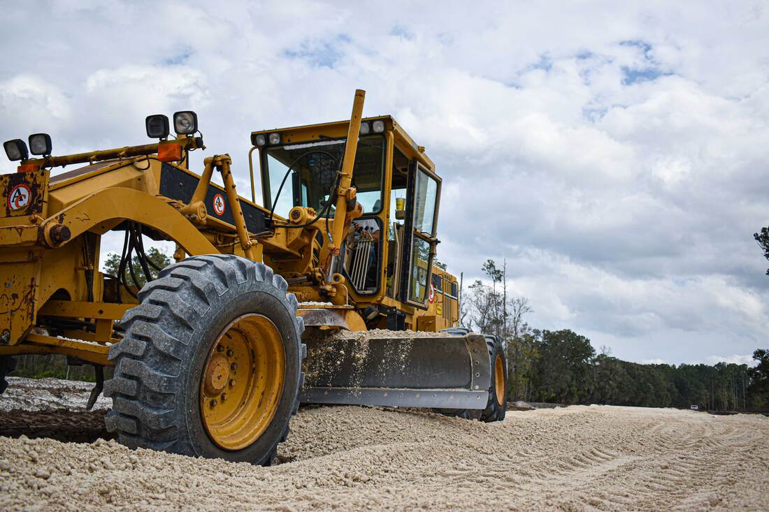 Site construction with heavy equipment grading access road